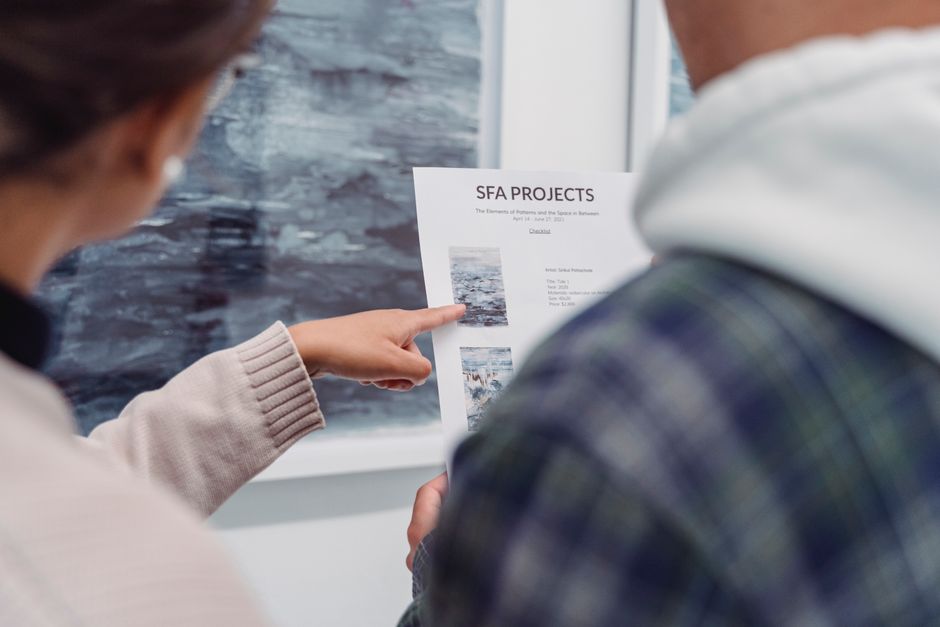 Close-up of a document being pointed at, discussing SFA projects.